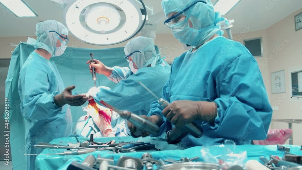 Surgeons are using drilling tools during an orthopedics operation Surgeons are using drilling tools during an orthopedics operation
