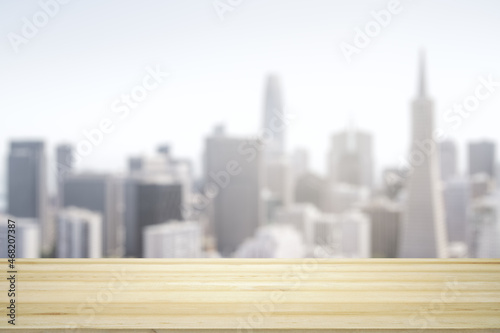 Empty table top made of wooden dies with blurry city view at daytime on background  template
