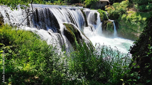 Fototapeta Naklejka Na Ścianę i Meble -  A beautiful sunny day at the Una River waterfall in Bosnia and Herzegovina.