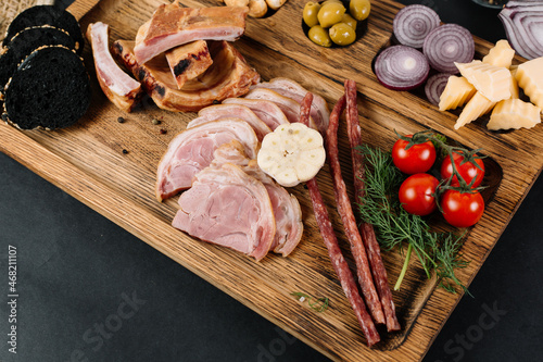 meat and vegetables on a wooden board