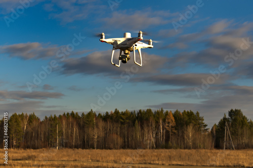 Professional quadcopter with high resolution camera onboard doing its job