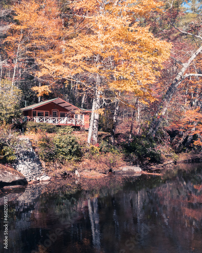 Mountain river house on the river with fall leaves orange