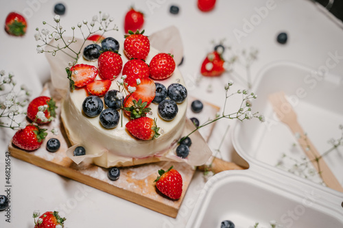 Bento cake with berries in a white package - container