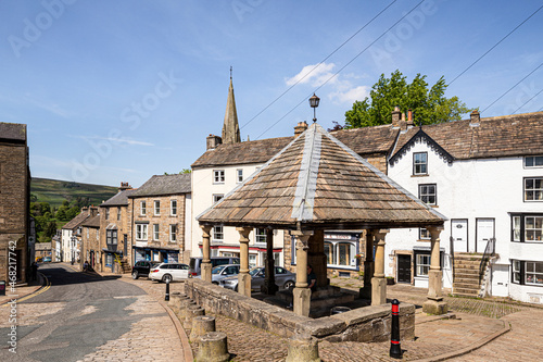 The 18th century stone built Market Cross in the square of the upland Pennines town of Alston, Cumbria UK