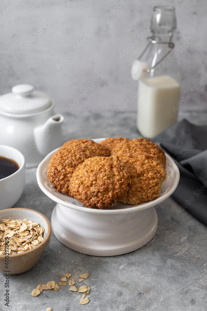 Delicious homemade oat cookies with a cup of coffee, healthy sweet snack, bright background. Delicious homemade oat cookies with a cup of coffee, healthy sweet snack, bright background.
