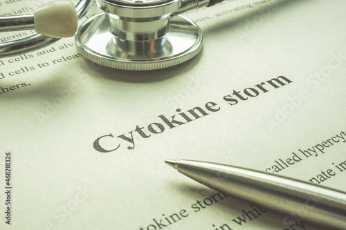 Page about cytokine storm, stethoscope and pen. photo
