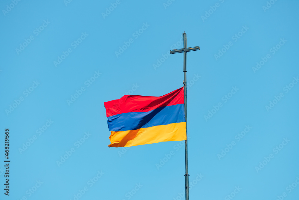 Armenian national flag and religious cross. The concept of patriotism, politics and religion in the country