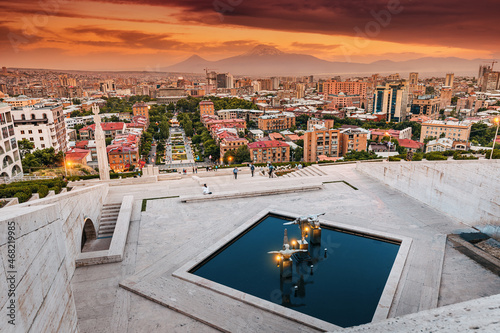 Scenic evening view from the stairs of Cascade monument to the colorful sunset over rooftops of Yerevan city and symbol of Armenia - Mount Ararat photo