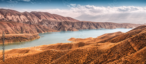 A picturesque reservoir with blue water in an arid area. The concept of recreation on the Azat River in Armenia and land reclamation