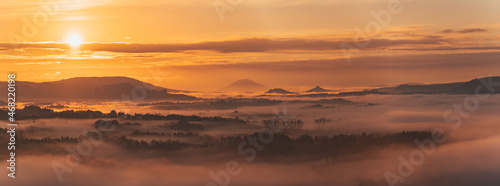 Foggy autumn sunrise with sleeping village