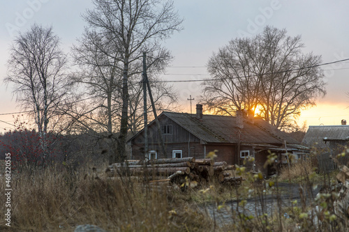 Kem, Karelia, Russia, - November 2021,Old wooden house with five walls at sunset in backlight