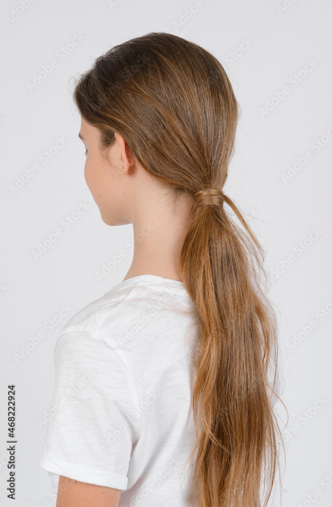 model samples , portrait of a teenage girl with long hair from the back on a white