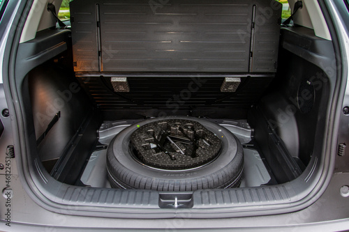 Fotografie, Obraz Spare wheel in the trunk of a modern car