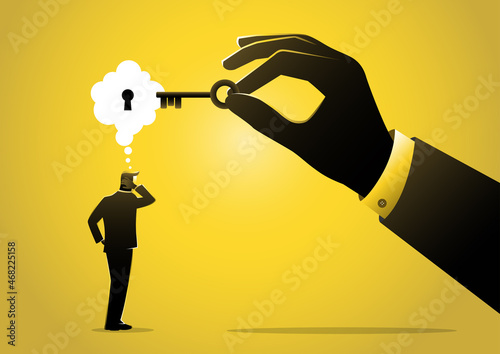 Man holding a key unlocking businessman mind