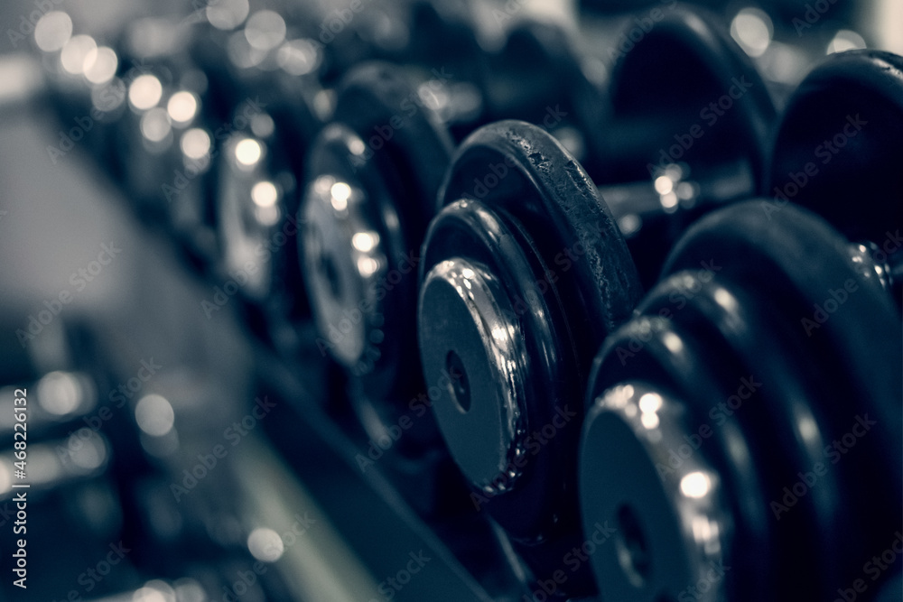 A rack with dumbbells in the gym or fitness club. Doing sports and fitness. Bodybuilding. A rack with dumbbells in the gym or fitness club. Doing sports and fitness. Bodybuilding.