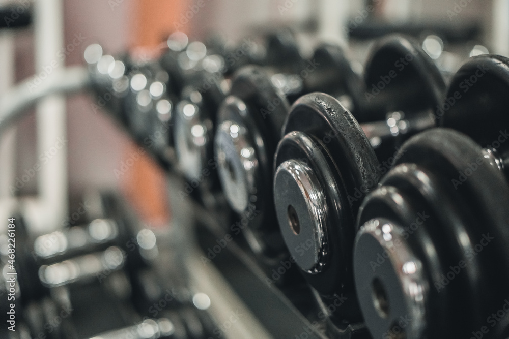 Fototapeta premium A rack with dumbbells in the gym or fitness club. Doing sports and fitness. Bodybuilding.