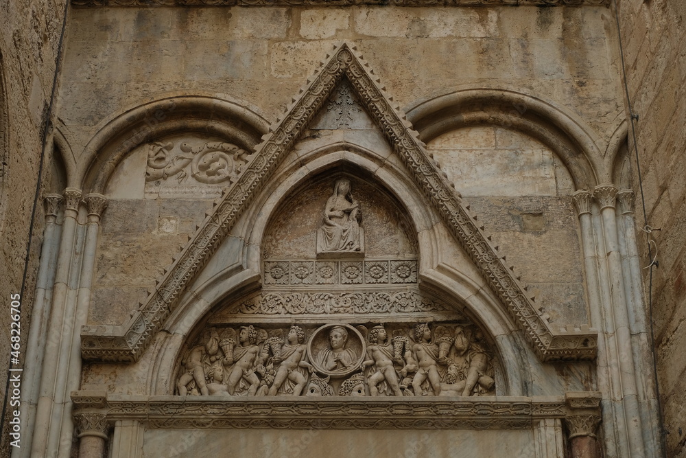 Tympanum and portal of the transept. Decorations on the stone of the cathedral of Cagliari..