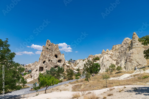 GOREME, TURKEY - AUGUST 19, 2021: Unique geological formations in Goreme Open Air Museum at sunny day in Cappadocia