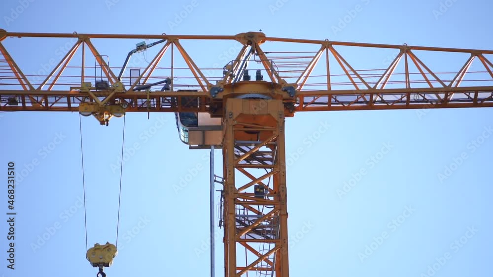 Construction crane on blue sky background close up Construction crane on blue sky background close up