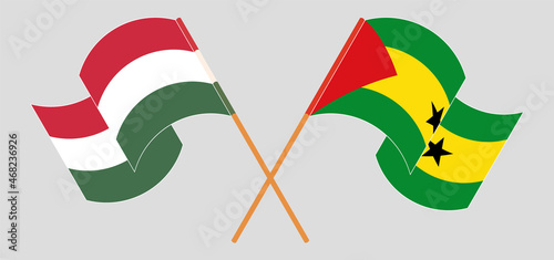 Crossed and waving flags of Hungary and Sao Tome and Principe