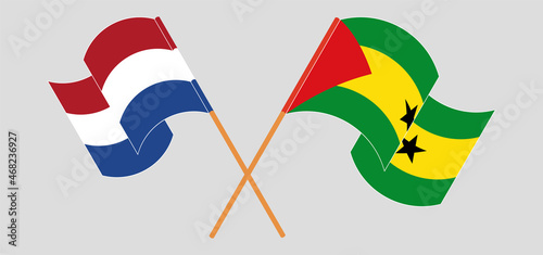 Crossed and waving flags of the Netherlands and Sao Tome and Principe