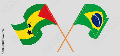 Crossed and waving flags of Sao Tome and Principe and Brazil