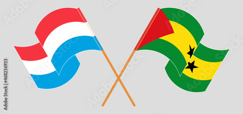 Crossed and waving flags of Luxembourg and Sao Tome and Principe