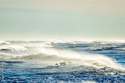 Large waves on the beach of Ebro delta in Spain on a sunny day
