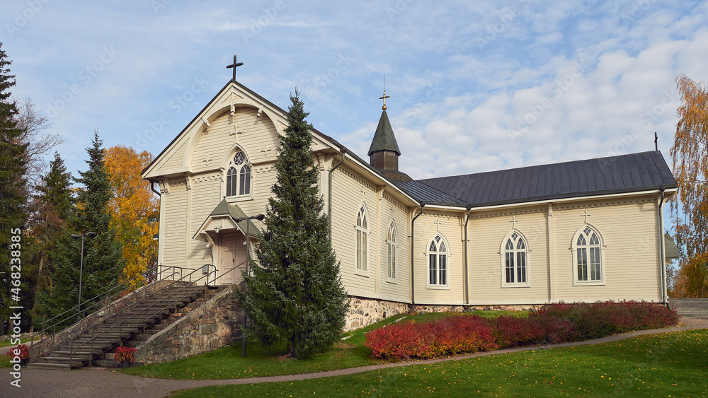 Fototapeta premium Lutheran Church in the Finnish town of Askola: autumn, colorful trees, sunny day.