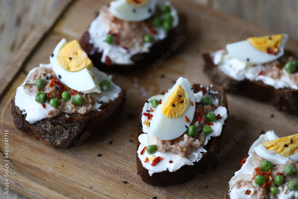 Healthy toast with cream cheese, tuna and egg. Diet food. Keto toast. Healthy toast with cream cheese, tuna and egg. Diet food. Keto toast.