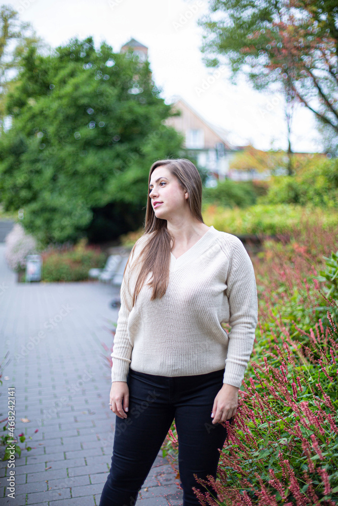 Fototapeta premium White european woman in white sweater in park