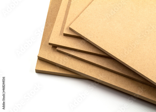 Raw mdf boards piled up, ready to paint.