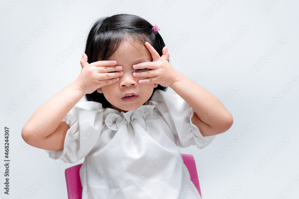 Little child girl peeping through her hand with one eye. On isolated white background. Preschool aged 4-5 years old. Little child girl peeping through her hand with one eye. On isolated white background. Preschool aged 4-5 years old.