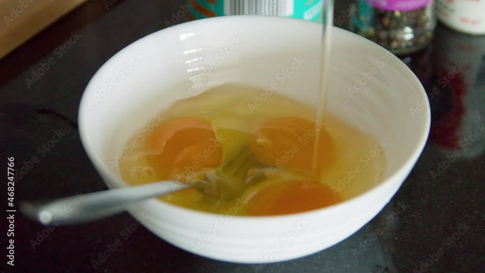 Three egg yolks in bowl with fork Three egg yolks in bowl with fork