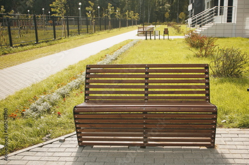 wooden bench on street in new neighborhood