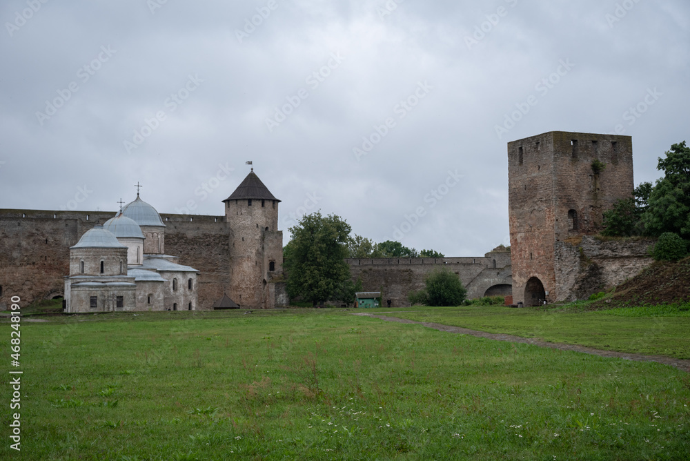 Courtyard of Ivangorod Fortress. View to churches of Saint Nicholas and Dormition of the Mother of God, walls and towers. Ivangorod, Russia