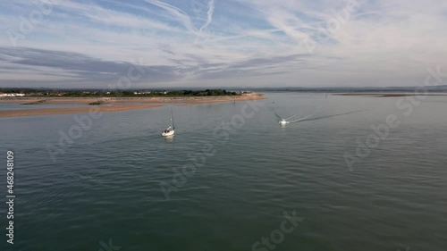 Aerial view of small vessels yachts sail in front of Hayling Beach off the coast of Southsea on a sunny morning. Bracklesham Bay.  photo