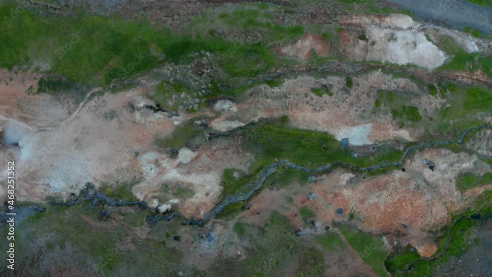 Overhead aerial view of geothermal area in Iceland with smoking fumaroles in Iceland. Top down view of amazing steaming craters landscape. Beauty in nature Overhead aerial view of geothermal area in Iceland with smoking fumaroles in Iceland. Top down view of amazing steaming craters landscape. Beauty in nature
