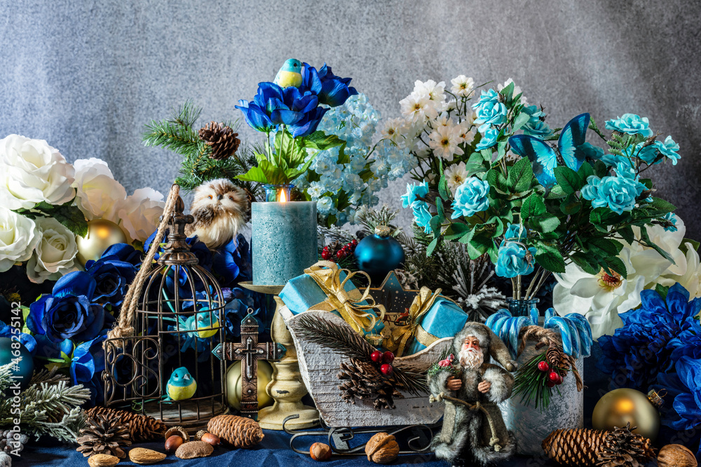 Fototapeta premium blue Christmas with Santa blue candy canes flowers cross birds butterfly candle and blue presents in white sleigh on blue
