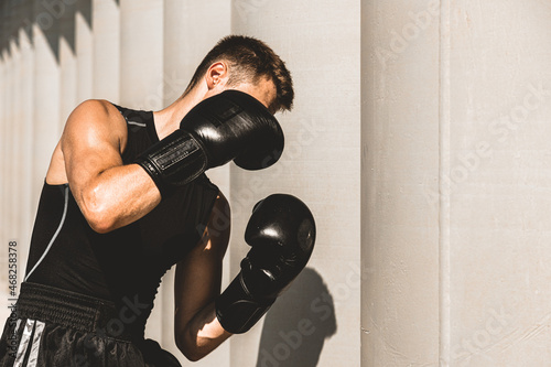 Man exercising and fighting in outside, boxer in gloves. male boxer portrait