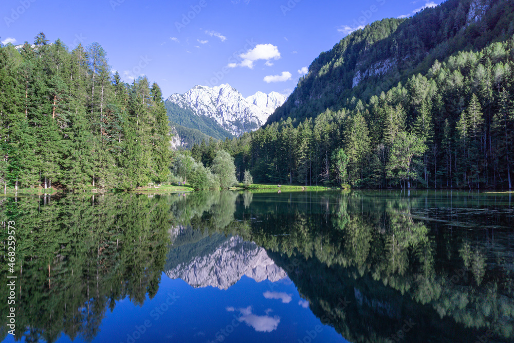 Lake with Slovenian Alps in background and the reflection of mountains in the water