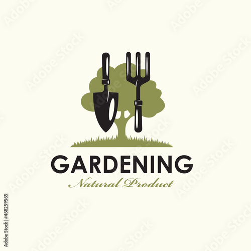 gardening emblem with trowel spade, garden fork and green tree