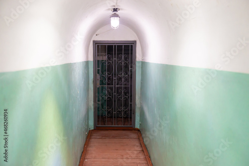 Corridor passage with door and lights in empty tunnel