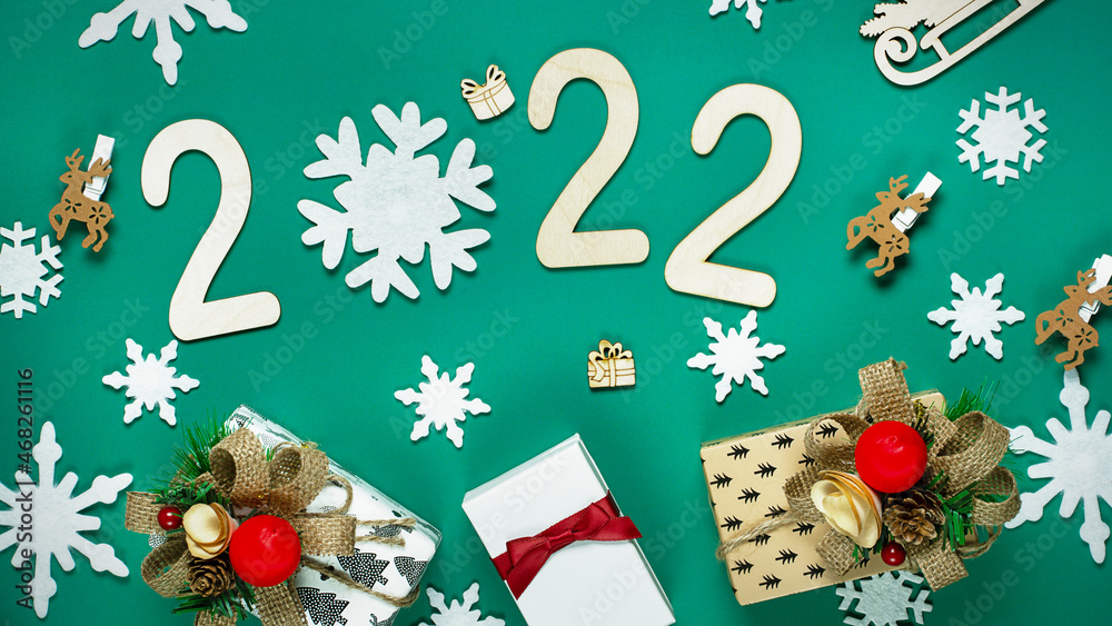 Christmas composition made of Christmas decoration and 2022 numbers on White background. Minimal concept of Xmas and New Year