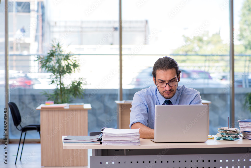 Young male accountant working in the office Young male accountant working in the office