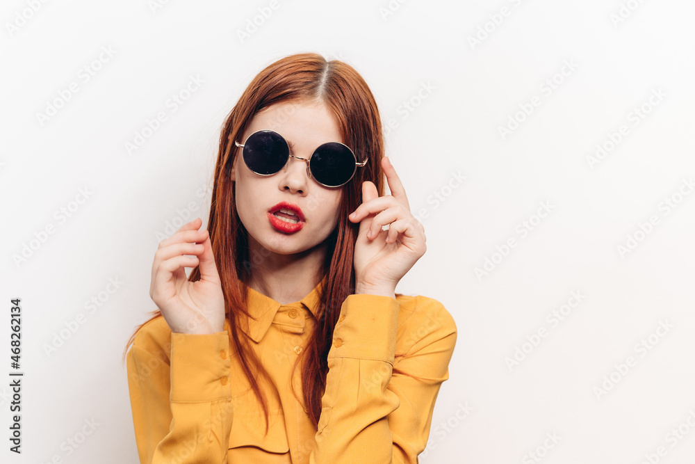 fashionable woman in yellow shirt sunglasses posing