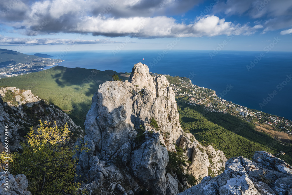 High rocks Ai-Petri of Crimean mountains. Black sea coast and blue sky with clouds in autumn. Russia