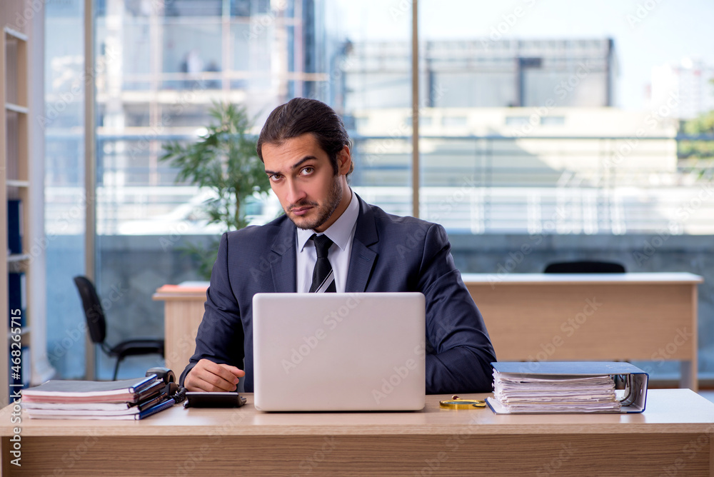 Young businessman employee working in the office Young businessman employee working in the office