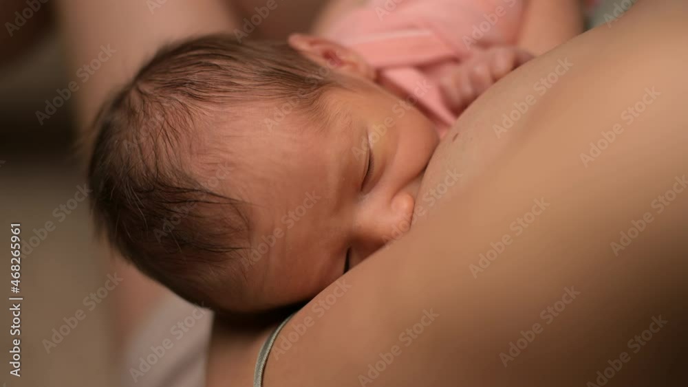 Newborn baby drinking mother's milk, close-up Newborn baby drinking mother's milk, close-up