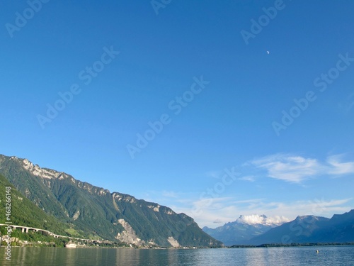 Lake in Italy during spring with blooming flowers and green trees on the shore